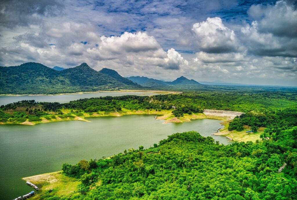Breathtaking aerial view of lush green landscape with a lake and mountains in Indonesia.